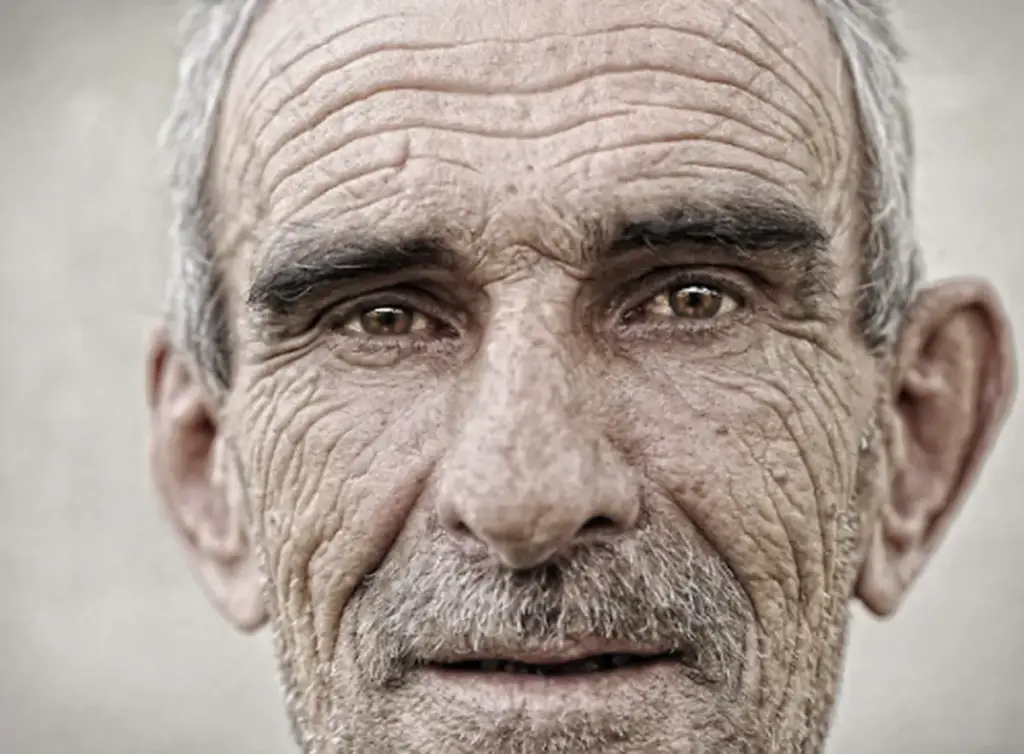 Portrait of an elderly man with deep wrinkles